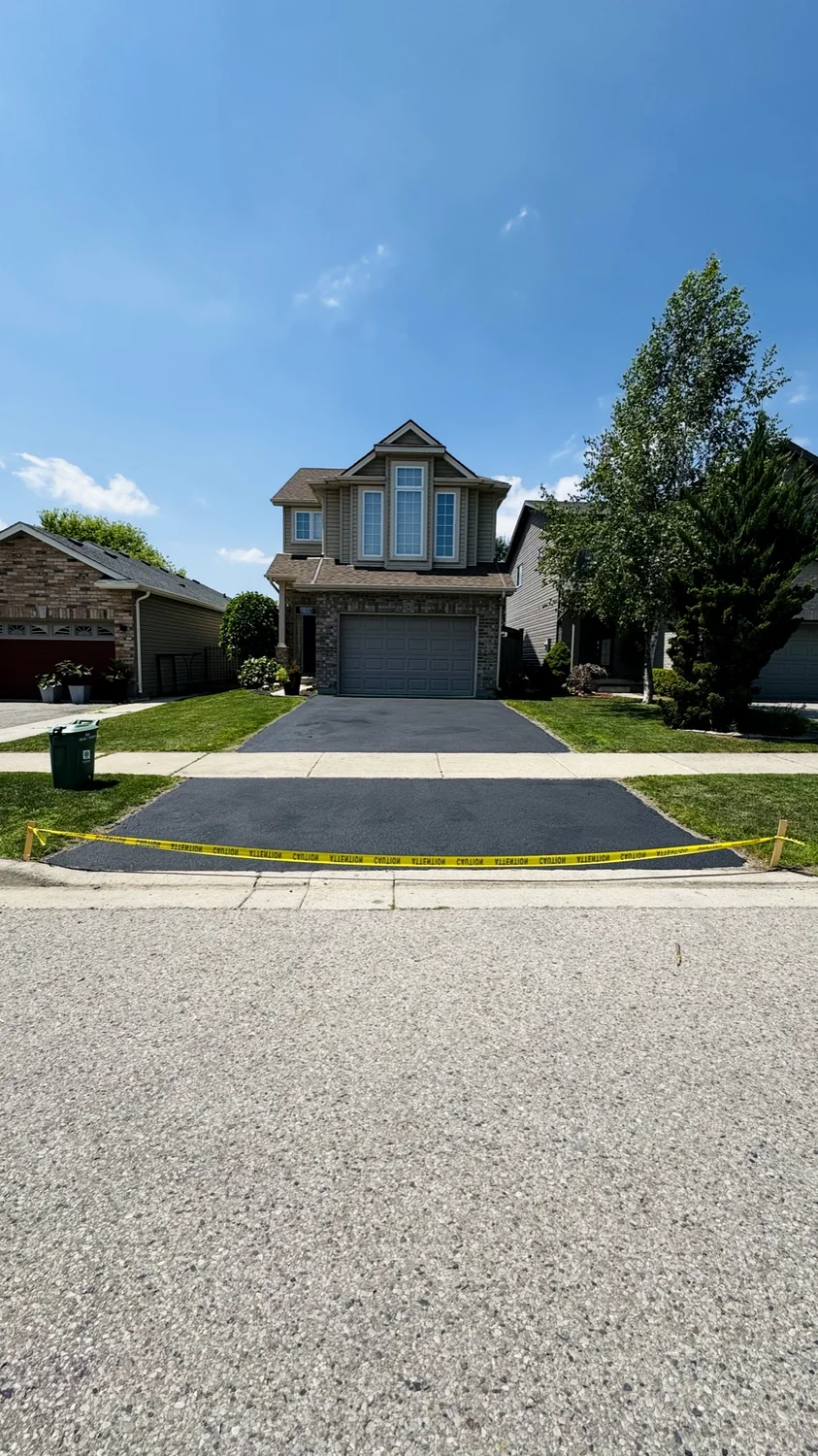 Finished asphalt driveway sealing project in London, Ontario