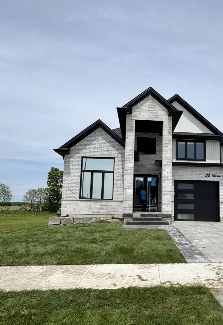 Residential window cleaning on a modern exterior home